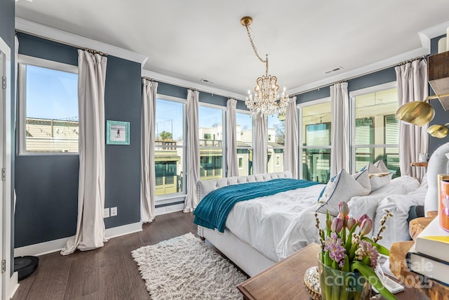 bedroom featuring visible vents, baseboards, dark wood finished floors, an inviting chandelier, and access to exterior