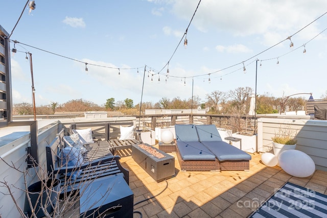 view of patio / terrace with an outdoor living space with a fire pit