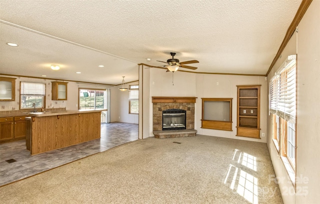 unfurnished living room with a textured ceiling, lofted ceiling, light colored carpet, ceiling fan, and ornamental molding