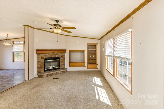 unfurnished living room featuring a textured ceiling, crown molding, ceiling fan, and a healthy amount of sunlight