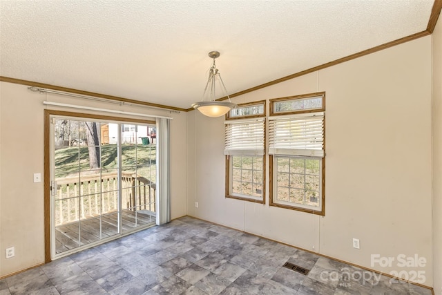 unfurnished room featuring a textured ceiling, ornamental molding, and visible vents