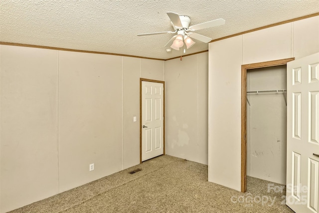 unfurnished bedroom featuring visible vents, light carpet, and a textured ceiling