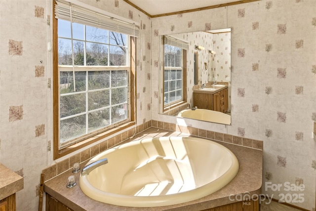 full bathroom with wallpapered walls, vanity, and a bath