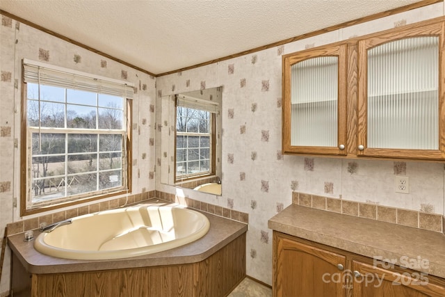 full bathroom featuring a bath, lofted ceiling, a textured ceiling, and wallpapered walls