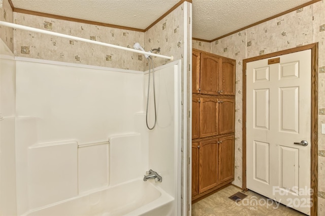 full bathroom featuring bathtub / shower combination, wallpapered walls, crown molding, and a textured ceiling