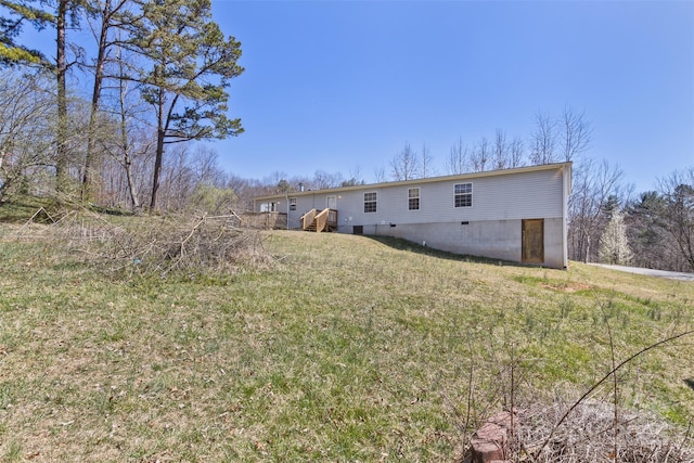 rear view of property featuring a yard