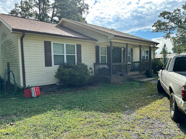 view of front of home with covered porch and a front yard