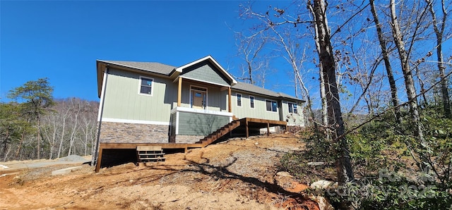 exterior space with stone siding and stairway