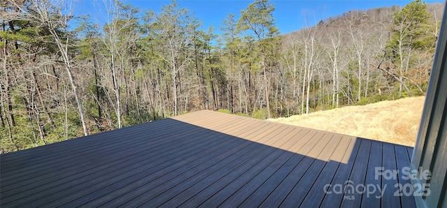 wooden deck featuring a wooded view