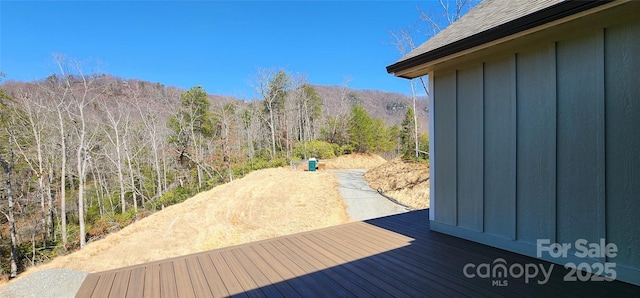 wooden deck with a forest view