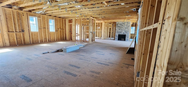 miscellaneous room featuring a stone fireplace