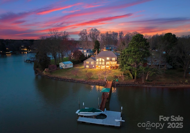 property view of water with boat lift and a dock