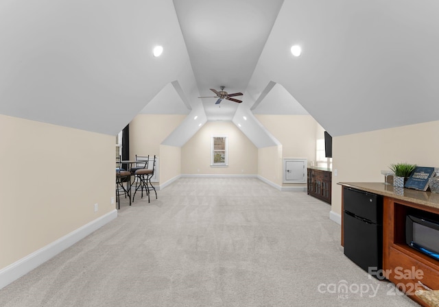 additional living space with a ceiling fan, baseboards, recessed lighting, vaulted ceiling, and light carpet