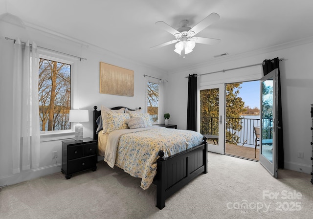 bedroom with access to outside, light colored carpet, visible vents, and ornamental molding