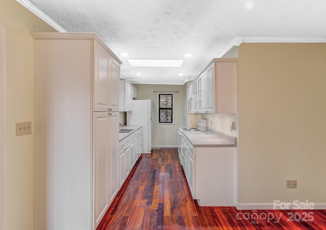 kitchen with white appliances, dark wood-style floors, ornamental molding, and light countertops