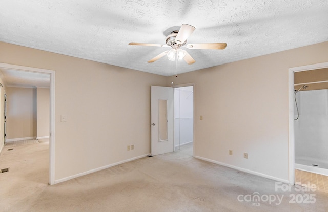 unfurnished bedroom with a textured ceiling, baseboards, and carpet floors