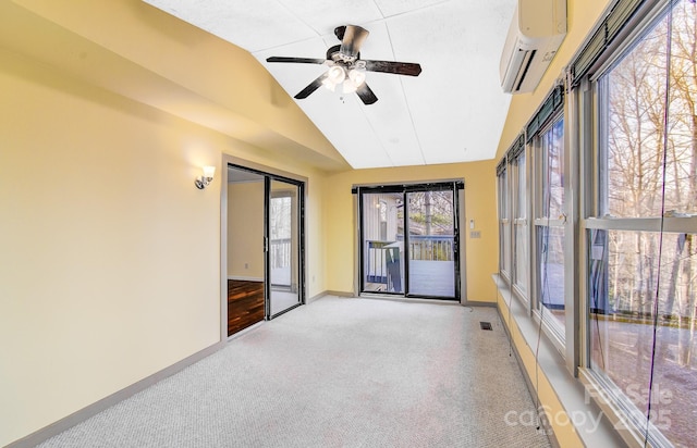 unfurnished sunroom featuring a wall unit AC, a ceiling fan, visible vents, and vaulted ceiling