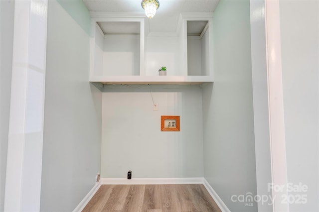 washroom featuring laundry area, hookup for a washing machine, wood finished floors, and baseboards