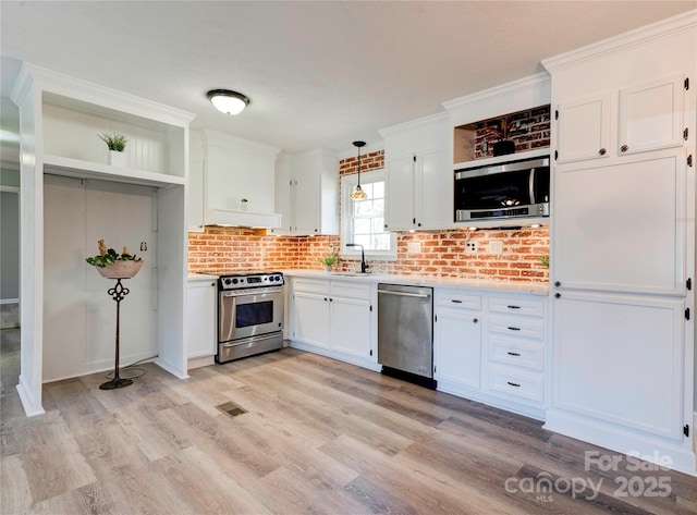 kitchen featuring open shelves, stainless steel appliances, and white cabinetry