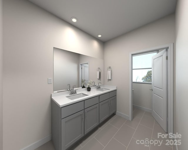 full bathroom with a sink, baseboards, double vanity, and tile patterned flooring