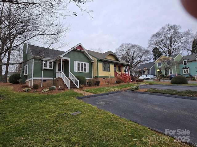 bungalow featuring a front yard and crawl space