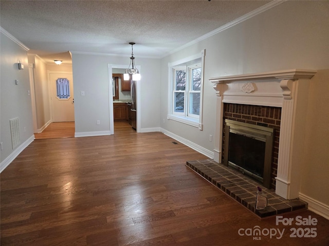 unfurnished living room with visible vents, crown molding, a fireplace, a textured ceiling, and dark wood-style flooring