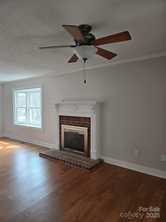 unfurnished living room with a brick fireplace, wood finished floors, and ornamental molding