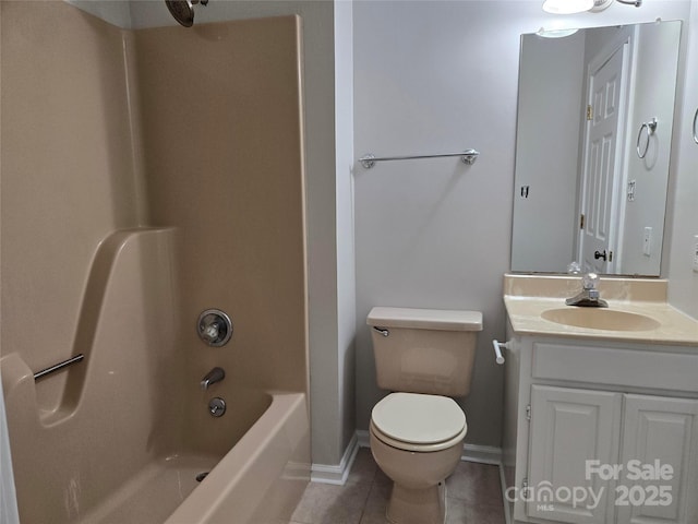 bathroom featuring vanity, baseboards, tile patterned flooring, bathing tub / shower combination, and toilet