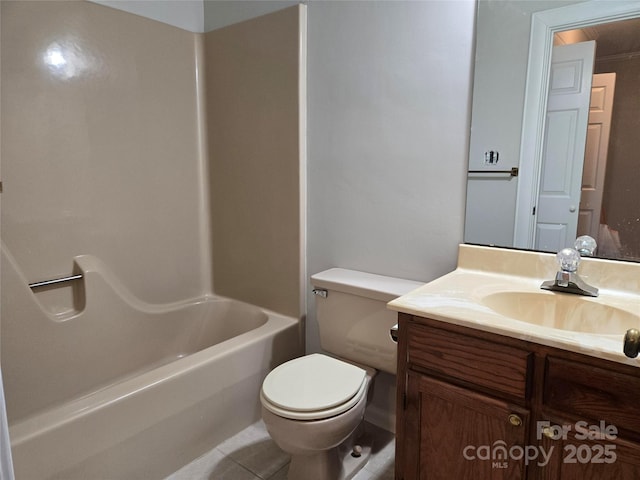 bathroom with vanity, toilet, and tile patterned flooring