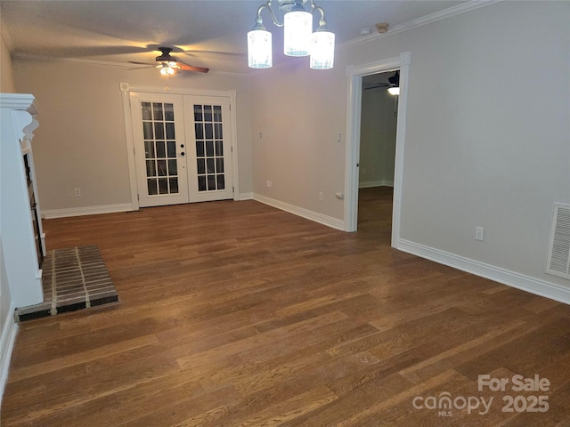 spare room featuring visible vents, baseboards, ornamental molding, french doors, and wood finished floors