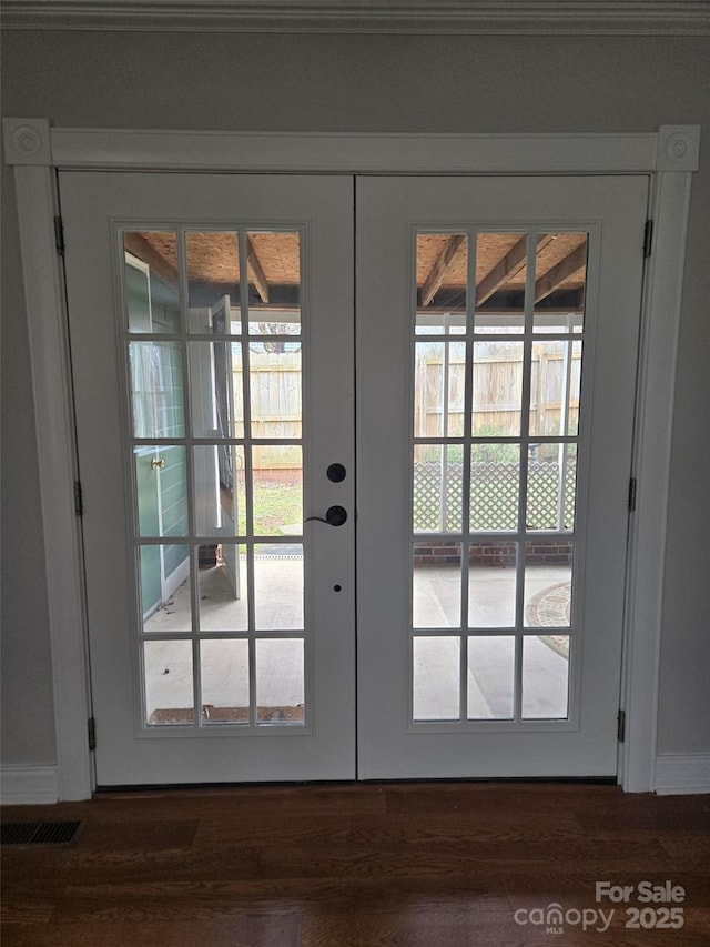 doorway to outside with visible vents, french doors, and wood finished floors