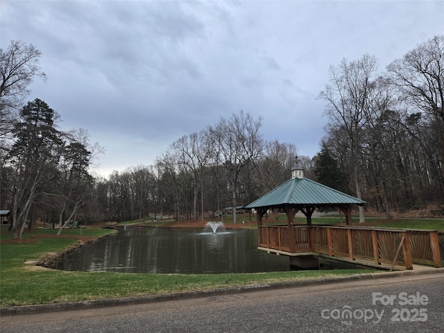 view of water feature with a gazebo and a wooded view