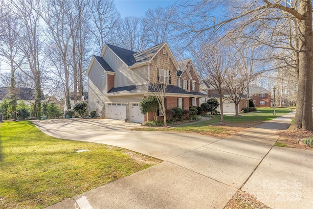 view of home's exterior with brick siding, a garage, a yard, and driveway