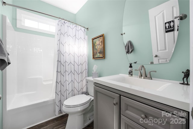 bathroom with vanity, toilet, wood finished floors, and shower / bath combo with shower curtain