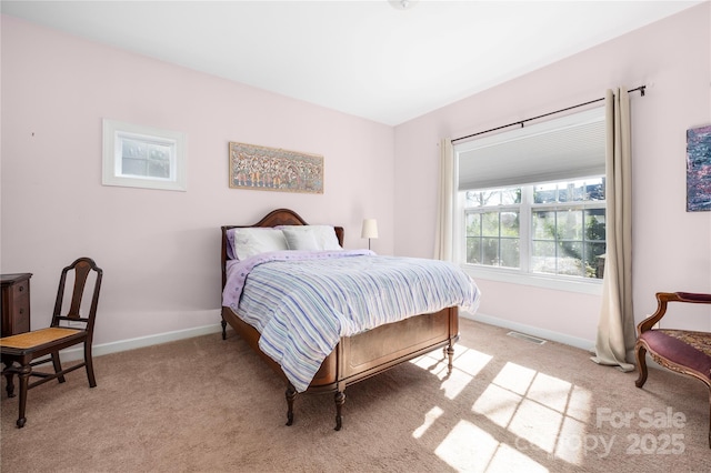 bedroom featuring visible vents, light colored carpet, and baseboards