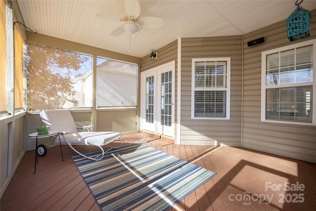 unfurnished sunroom featuring a ceiling fan