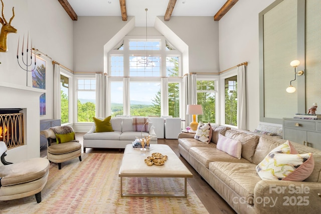 68 Cinch Knot Dr, Nebo, NC 28761 - living area with a high ceiling, beam ceiling, wood finished floors, and a lit fireplace