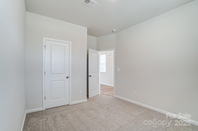 unfurnished bedroom with visible vents, baseboards, and carpet flooring