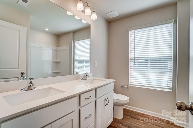 bathroom featuring a sink, visible vents, and toilet