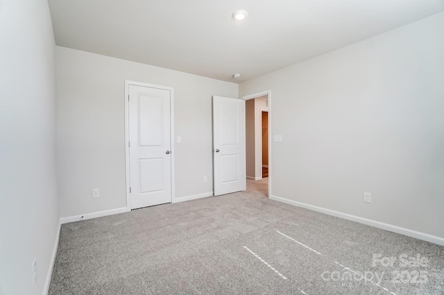 unfurnished bedroom with carpet and baseboards