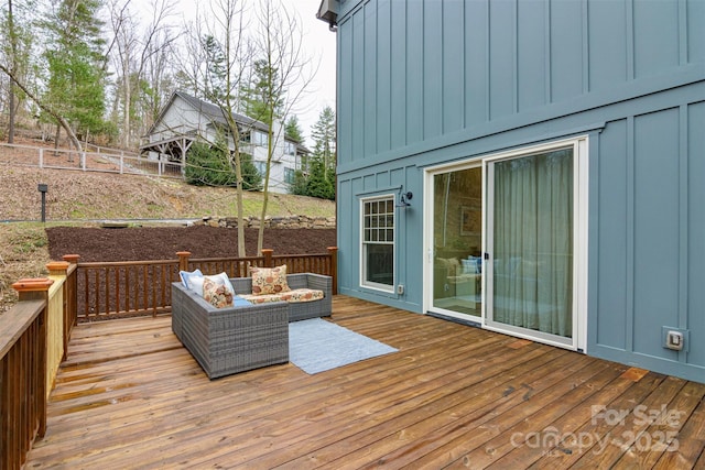 wooden terrace featuring outdoor lounge area and fence