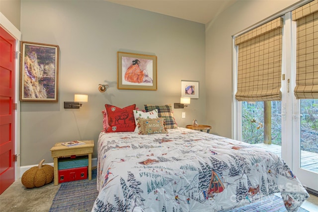 bedroom featuring baseboards and access to outside