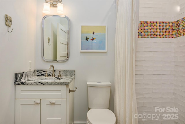 full bath with vanity, toilet, and a tile shower