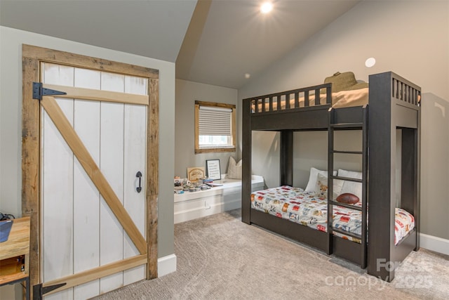 bedroom featuring baseboards, carpet, and vaulted ceiling