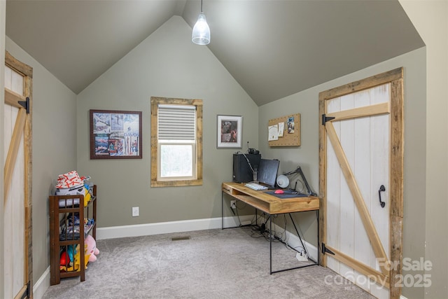 carpeted home office with vaulted ceiling and baseboards