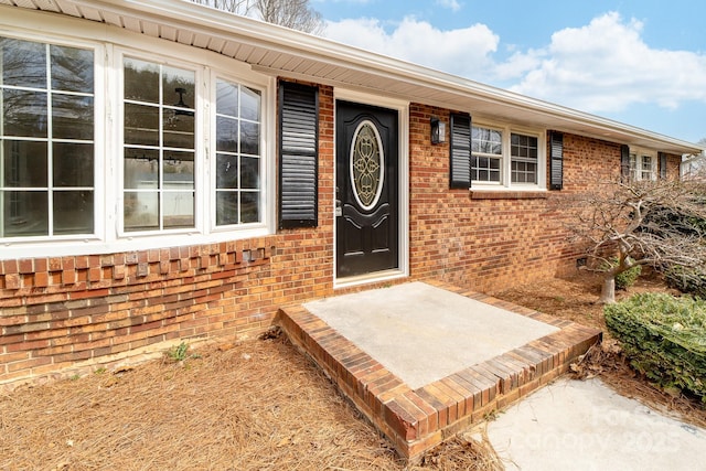 property entrance with brick siding