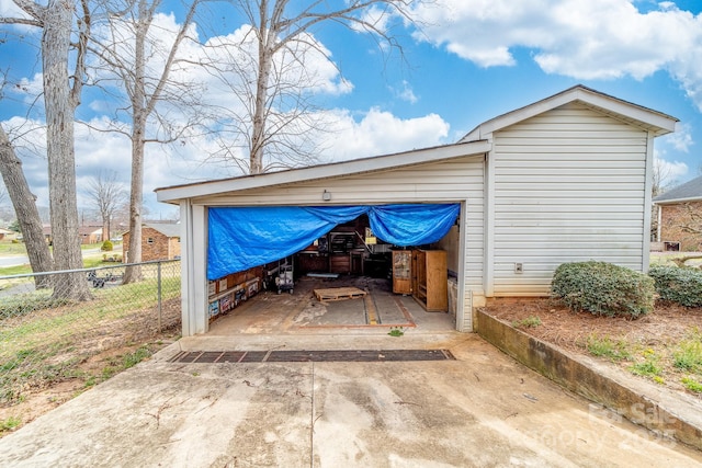 garage with driveway and fence