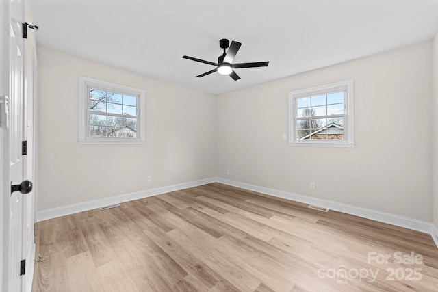 spare room featuring visible vents, baseboards, light wood-style floors, and a ceiling fan