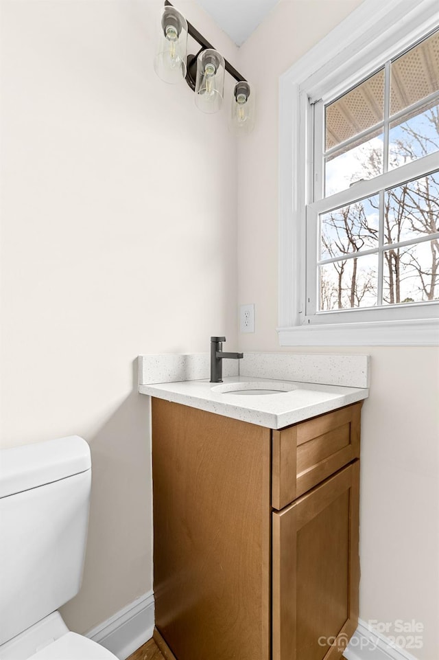 bathroom featuring vanity and toilet