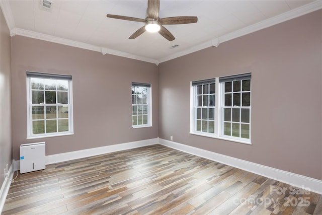 2005 Douglas Rd, Lancaster, SC 28720 - empty room featuring visible vents, wood finished floors, crown molding, baseboards, and ceiling fan